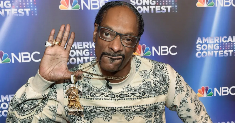 NBC'American Song Contest' wears a black and white bandana printed sweater and a massive gold chain.