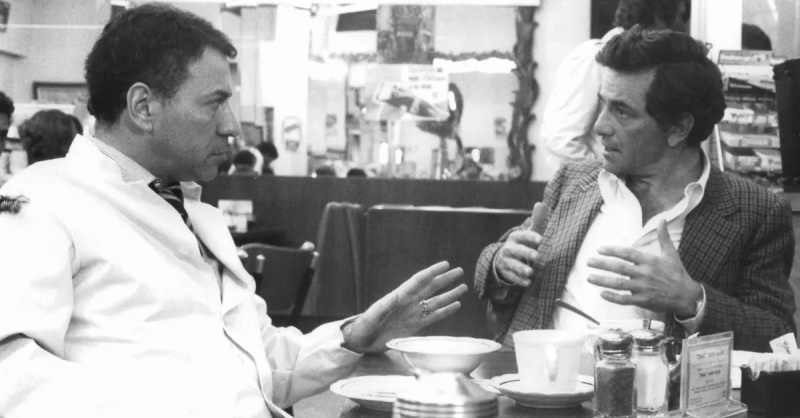 Peter Falk sentado em uma lanchonete conversando com Alan Arkin em uma cena do filme'The In-Laws', 1979.