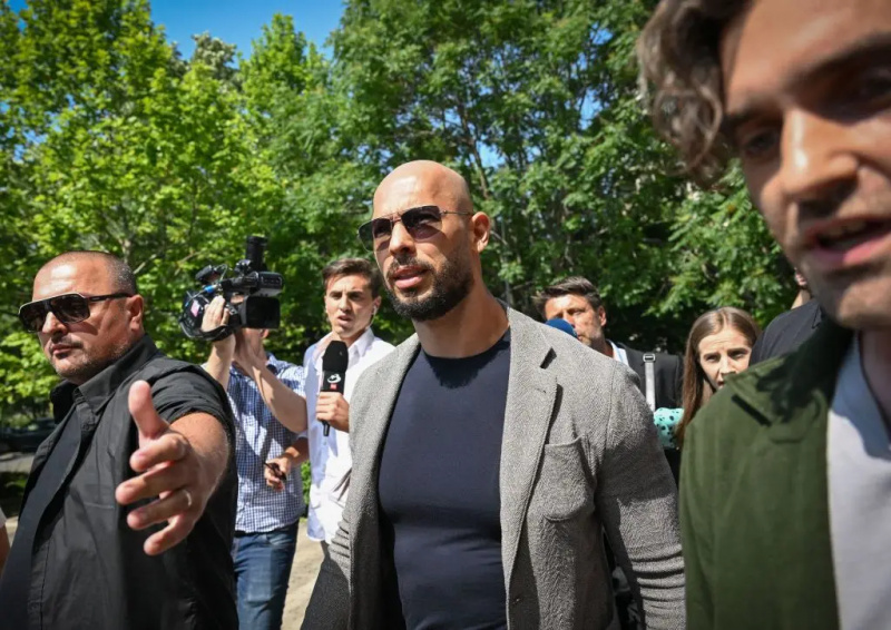 Andrew Tate omgivet af journalister