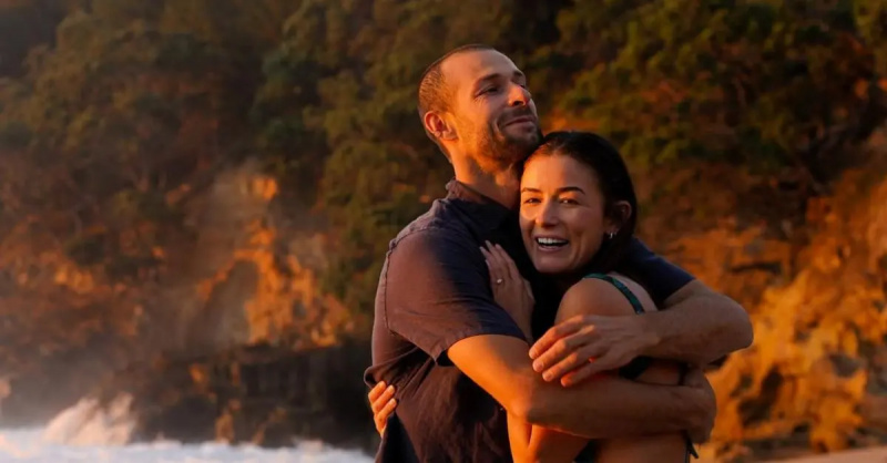 Scott"Scotty" Dobson holds Aesha Scott after proposing to her on the beach.