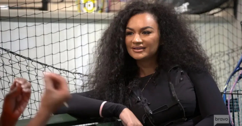 Кения's friend, Akilah, listening to Kenya while their daughters play tennis